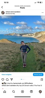 A white slim build lady on a green hiking trail on the Jurassic Coast